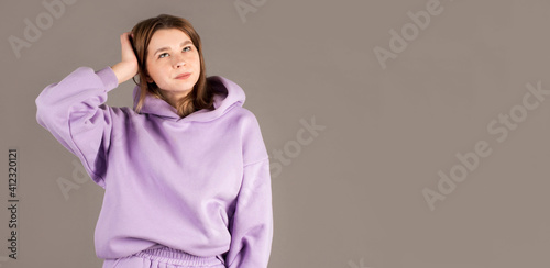 Young woman wearing purple sweater doubt expression, confuse and wonder concept, uncertain future isolated on gray background