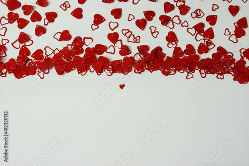 Fototapeta Naklejka Na Ścianę i Meble -  A red heart shaped confetti border with copy space.