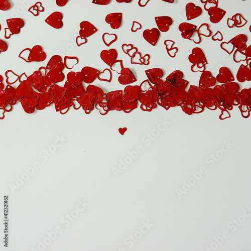 Fototapeta Naklejka Na Ścianę i Meble -  A red heart shaped confetti border with copy space.