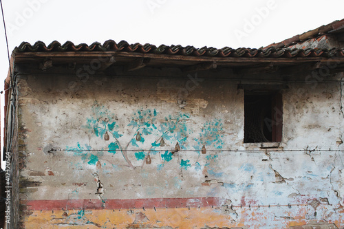 Very ancient wall painting leftovers on old building in Italy photo