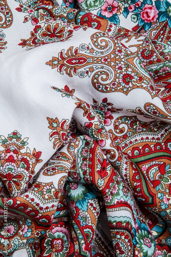 top view closeup on crumpled white cotton scarf with colorful oriental ornament