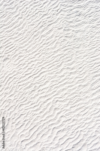 texture of snow-white sand with fine ripples on the beach