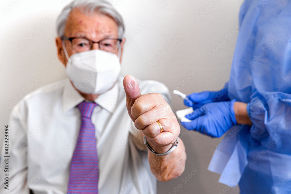 Elderly man makes all-is-well symbol after coronavirus vaccination Elderly man makes all-is-well symbol after coronavirus vaccination