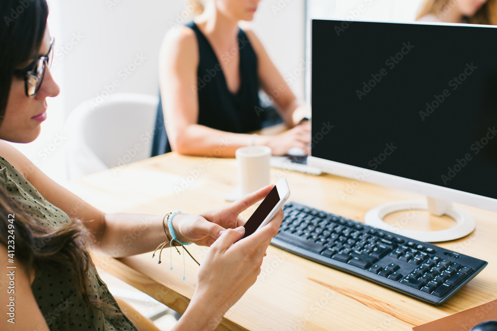 Closeup of a businesswoman using phone at office. Closeup of a businesswoman using phone at office.