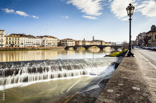 Arno River and Ponte alla Carraia Bridge in Florence, Italy photo