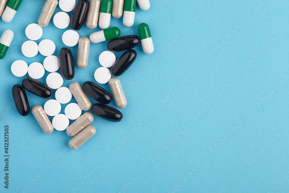 Closeup of white pils and colorful capsules. Heap of pills - medical background Closeup of white pils and colorful capsules. Heap of pills - medical background