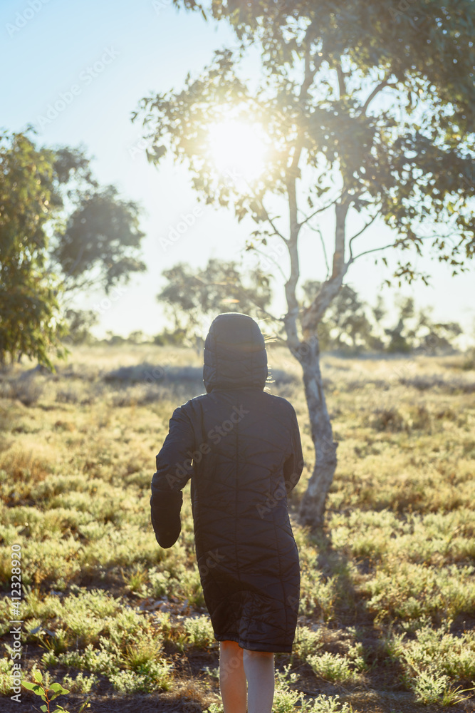 girl in winter parka in the country, with sun flare girl in winter parka in the country, with sun flare