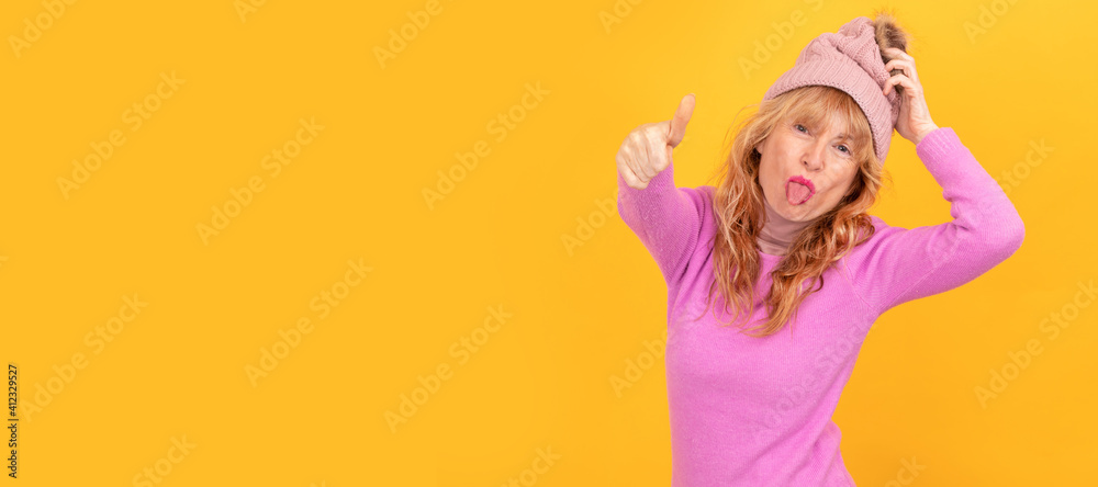 isolated rebellious senior woman sticking out her tongue