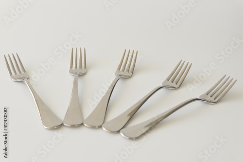 Five pastry forks isolated at a gray background