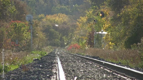 Autumn train tracks. Heat shimmer and haze on railroad tracks on a warm autumn day. Seeds blow by. Toronto, Ontario, Canada.
