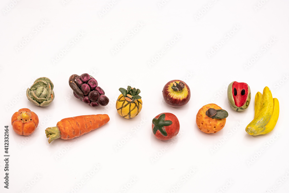 Mini mix of clay fruit on white background. Space for text