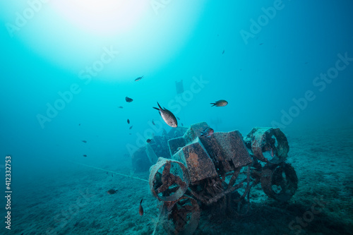 Underwater scooter sunken to make an artificial reef for fish to gather on an empty sea bed photo
