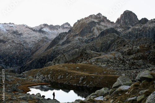 Scenic mountain landscape at fall with little human silhouette