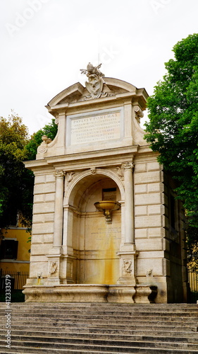 Rome, 05 May 2019: Ancient fountain in Piazza Trilussa originally built in 1613 on the opposite bank of the Tiber, in the background of Via Giulia, moved in 1898 to its current position photo