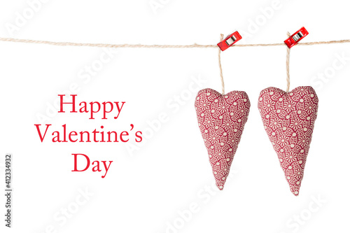 Valentine's card; two hearts hanging, isolated on a white background with text: Happy Valentine's day