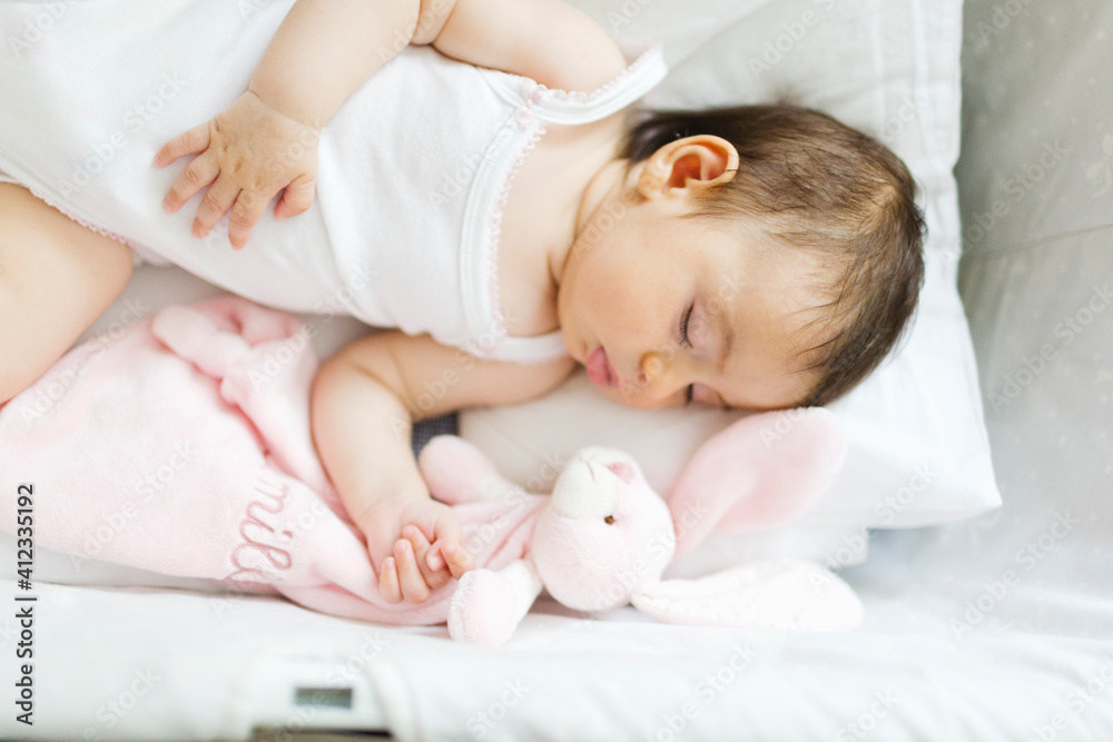 Cute baby girl sleeps deeply in the cradle Cute baby girl sleeps deeply in the cradle