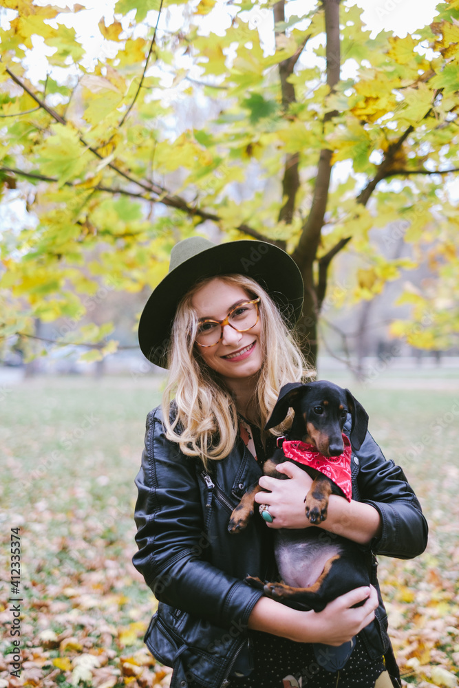 Young Woman Holding Dachshund Puppy Young Woman Holding Dachshund Puppy