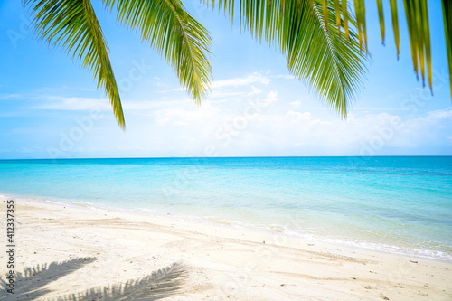 Fototapeta Naklejka Na Ścianę i Meble -  Tropical sea beach with sand and coconut tree in Bangka Belitung. Isolated island clear blue sky background. Ketawai Island