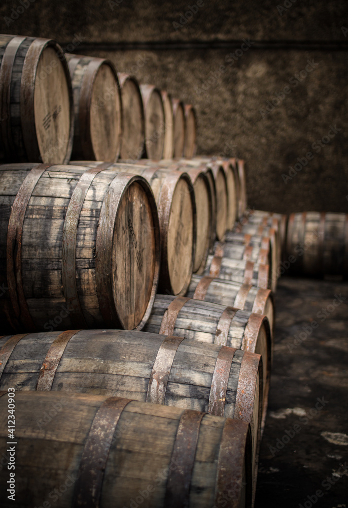 Wooden barrels and casks sit in a pile Wooden barrels and casks sit in a pile