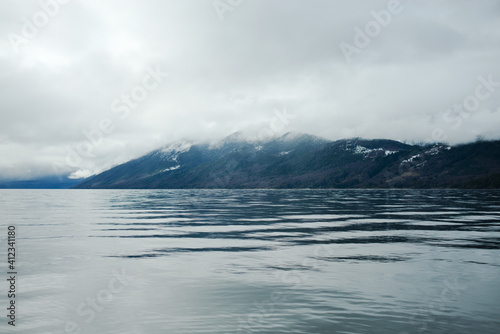Scenic view of a lake surrounded by snow capped mountains in Patagonia photo