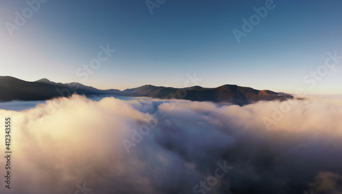 Mountains covered with fog early in the morning. © Артур Ничипоренко