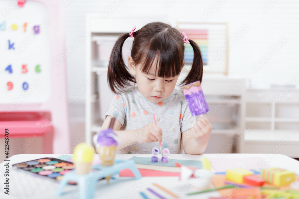 young girl decorating hand made craft for homeschooling young girl decorating hand made craft for homeschooling