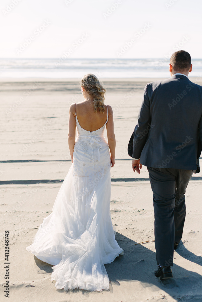Bride and Groom Walking to the Ocean Bride and Groom Walking to the Ocean