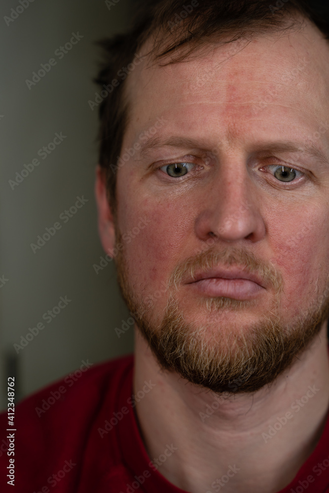 a close up portrait of a man in a red sweater and a disturbed facial expression and a desperate look a close up portrait of a man in a red sweater and a disturbed facial expression and a desperate look