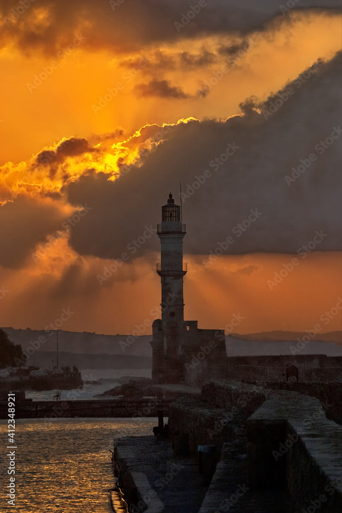 Seascape with popular Venetian harbor and lighthouse in Chania on Crete at sunset