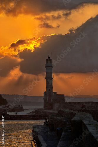 Seascape with popular Venetian harbor and lighthouse in Chania on Crete at sunset