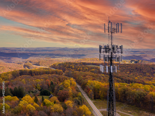 Aerial view of mobile phone cell tower over forested rural area of West Virginia to illustrate lack of broadband internet service photo