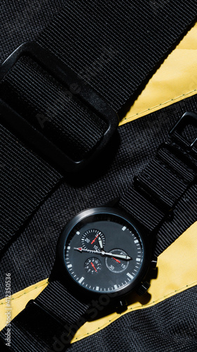 Military / police style watch on yellow and black nylon fabric photo