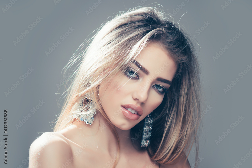 Fototapeta premium Fashion woman, portrait closeup. Jewelry shop and accessory. Earrings on sexy blonde woman, copy space.