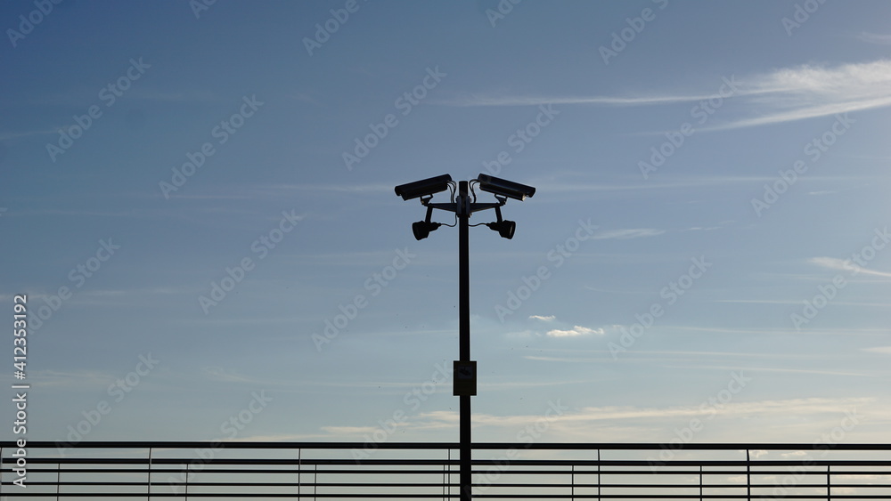 security cameras against sky background