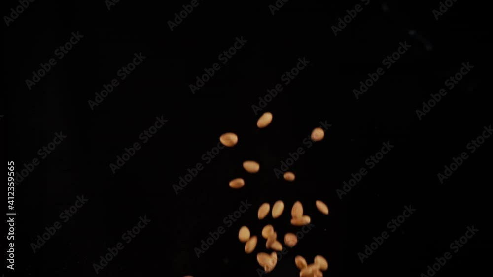 Slow motion explosion of almonds flying in flames