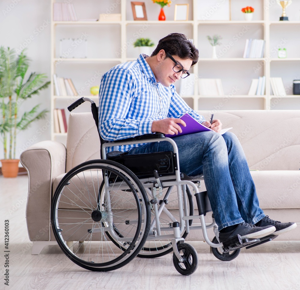 Young student on wheelchair in disability concept Young student on wheelchair in disability concept