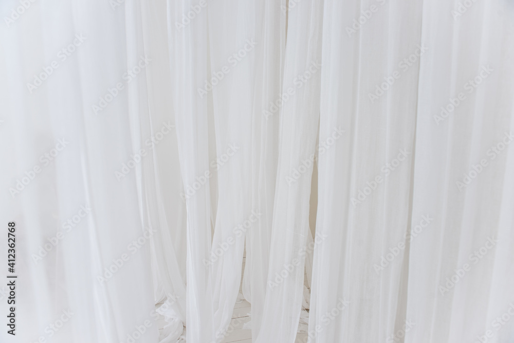 Fototapeta premium Background texture of white, airy stripes of chiffon fabric, tulle. Neutral colors. Minimalist interior decoration. Scandinavian style. Copy space