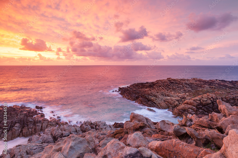 fiery sunset over rocky coastline fiery sunset over rocky coastline