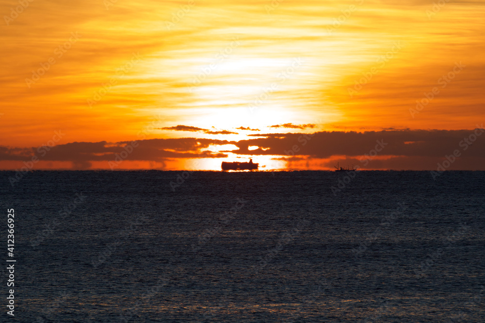 Spring Sunrise over the Pacific ocean in Chiba Japan. An amazing orange glow with wispy clouds makes this a beautiful background image. Spring Sunrise over the Pacific ocean in Chiba Japan. An amazing orange glow with wispy clouds makes this a beautiful background image.