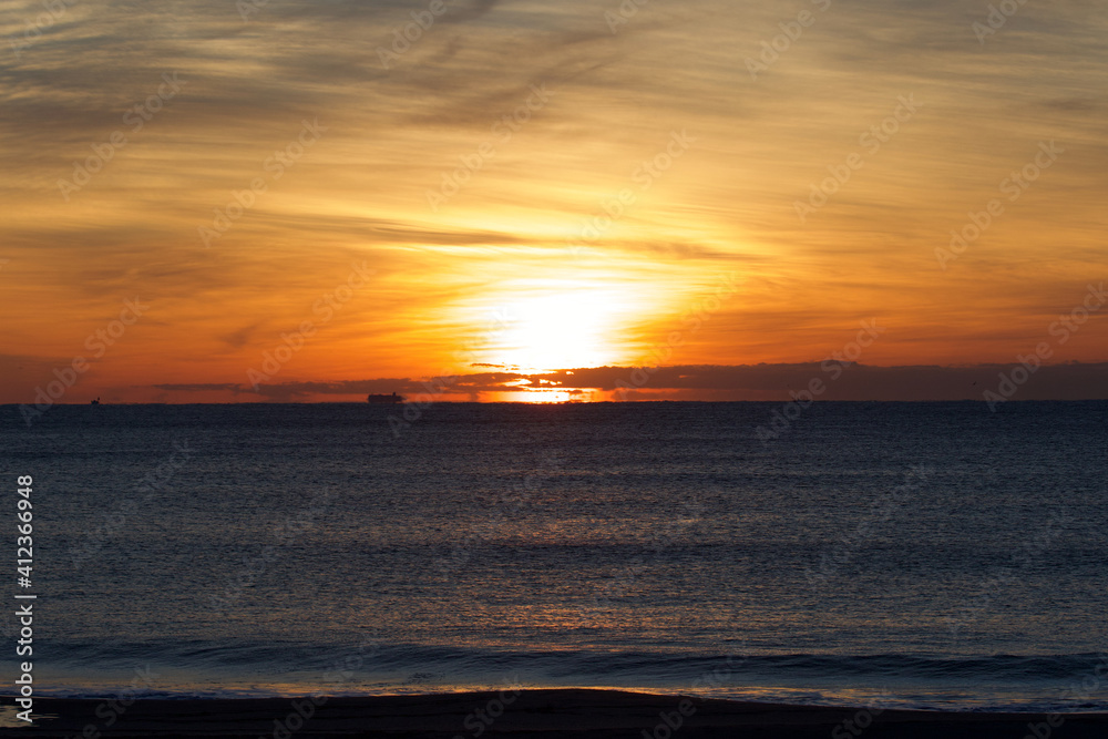 Spring Sunrise over the Pacific ocean in Chiba Japan. An amazing orange glow with wispy clouds makes this a beautiful background image. Spring Sunrise over the Pacific ocean in Chiba Japan. An amazing orange glow with wispy clouds makes this a beautiful background image.