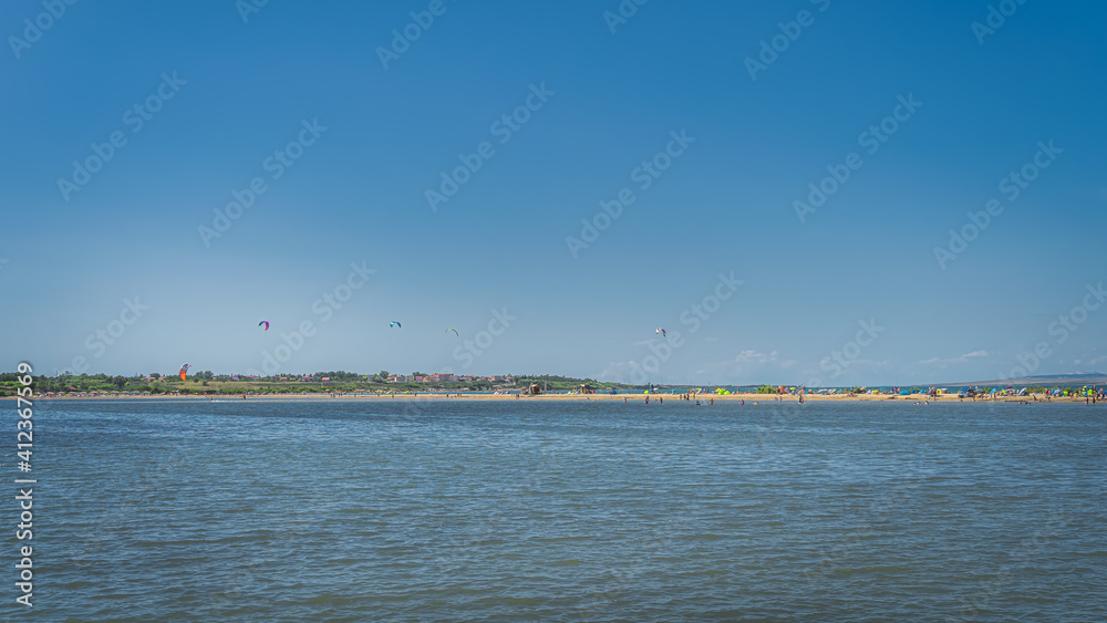 View on Zdrijac beach between Nin bay and Adriatic Sea with kite surfers, relaxing and sunbathing people, Croatia