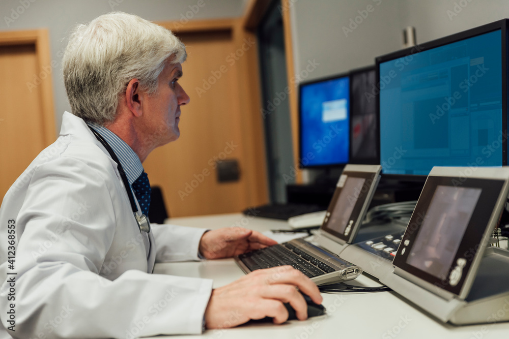 Adult doctor using computer Adult doctor using computer