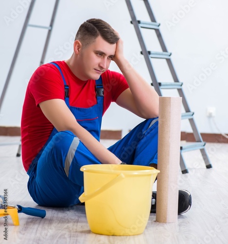 Contractor worker preparing for wallpaper decoration