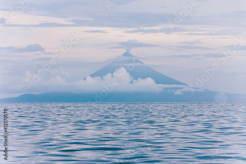 Volcano or mount Mayon blue silhouette and sea, Luzon, Philippines photo