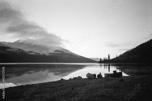 Canoe on edge of shoreline BC wilderness Bowron Lakes park photo