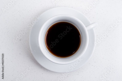 Coffee cup with espresso top view. White key.