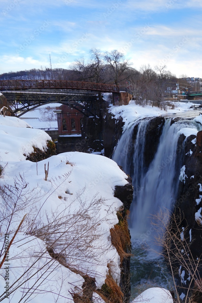 Winter view of the Great Falls of the Passaic River, part of the Paterson Great Falls National Historical Park in New Jersey, United States, after a snow storm.