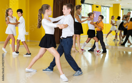 Fototapeta Naklejka Na Ścianę i Meble -  Young children enjoying of partner dance in class