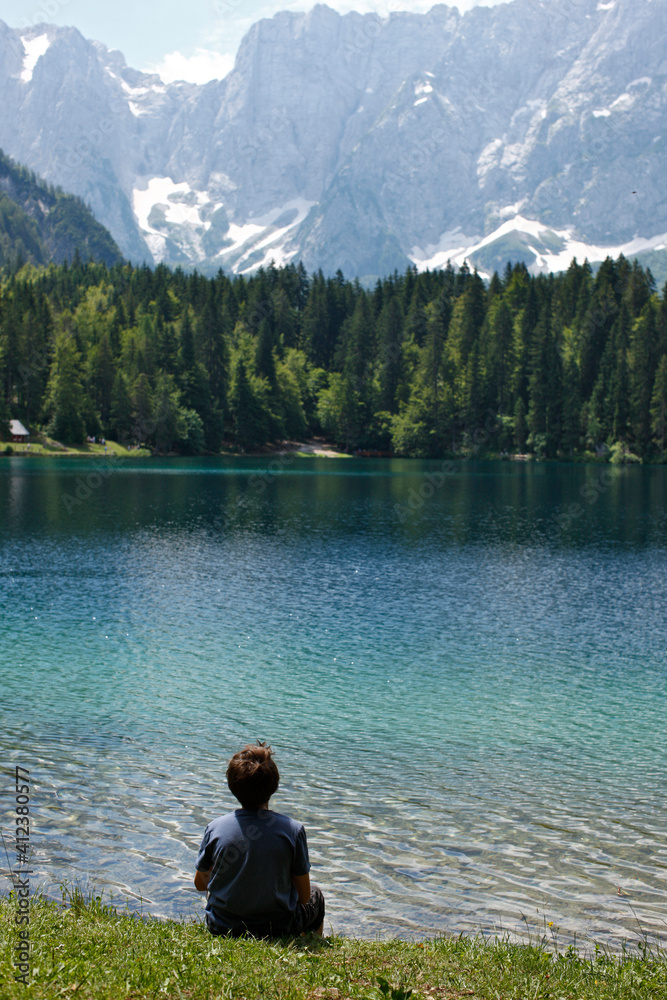 Boy sitting by the lake Boy sitting by the lake