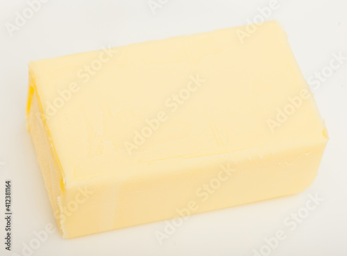 Piece of tasty fresh butter on white background..